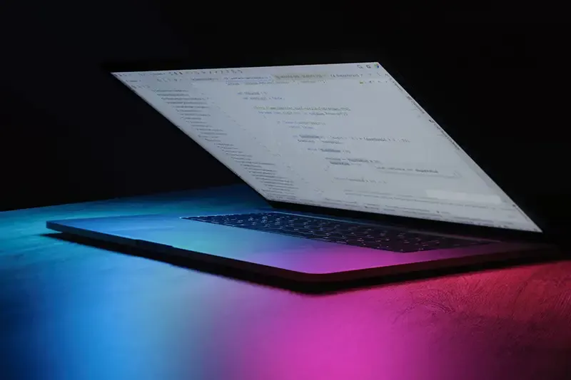 A custom coded website displayed on a laptop